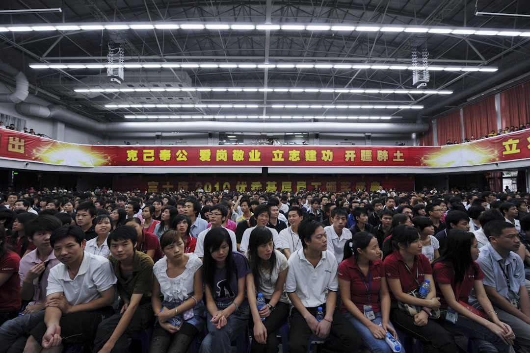 三十年來,90%以上的富士康工人都是幹半年到一年就走,所以富士康也不斷用「實習生」的方式招工,從職業學校直接拉人過來,以實習生的名義進工廠。從職業學校招工的好處是一批一批地招,成本大大減少了。2010年10月16日,深圳龍華鎮富士康工業園區基層員工頒獎典禮。