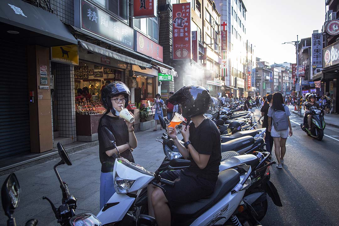 市民在台灣淡水街頭喝茶。