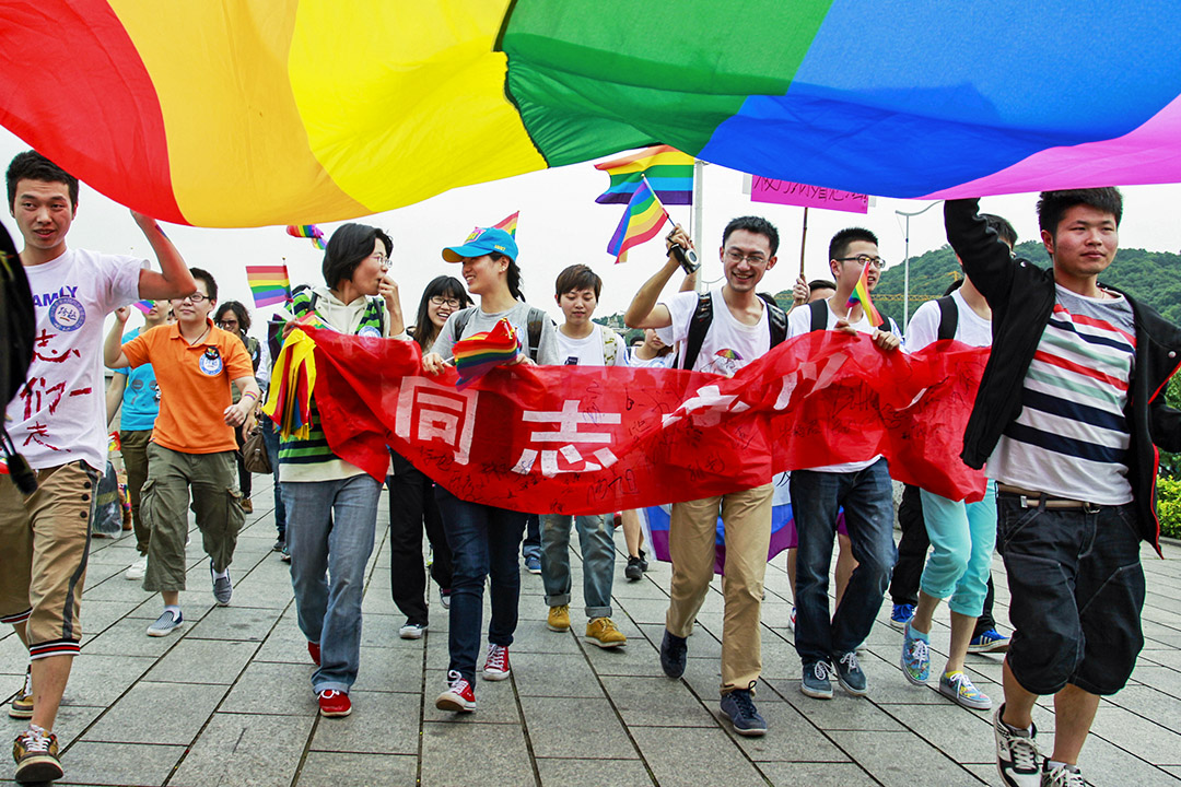 2013年5月17日,中國湖南省長沙市舉行的反歧視遊行中,年輕人舉著彩虹旗,,大約有一百人聚集在一起參加遊行。