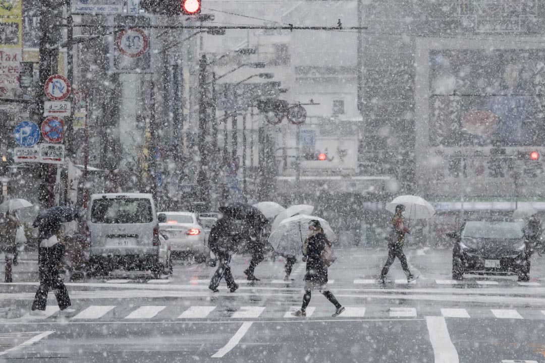 2020年3月29日,日本東京降雪,人們戴著口罩在淺草區過馬路。