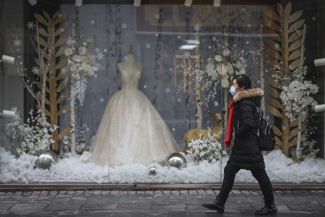 2020年1月22日,武汉一名女士在婚纱店前经过。