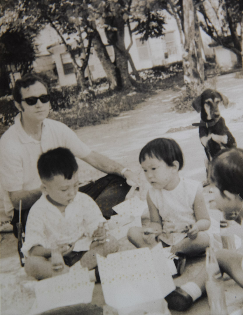 1972年,关尚义当上幼稚园的校监,与学生一起在草地上。
