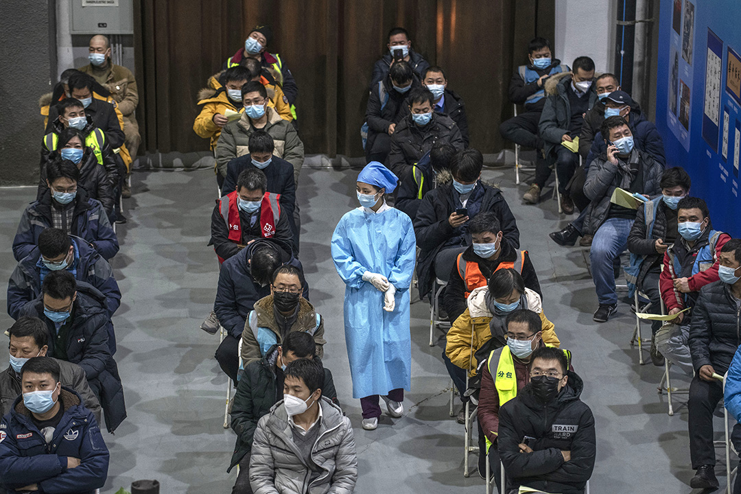 2021年1月15日中國北京,工人包括保安人員,在朝陽區的疫苗接種中心等待接種疫苗。