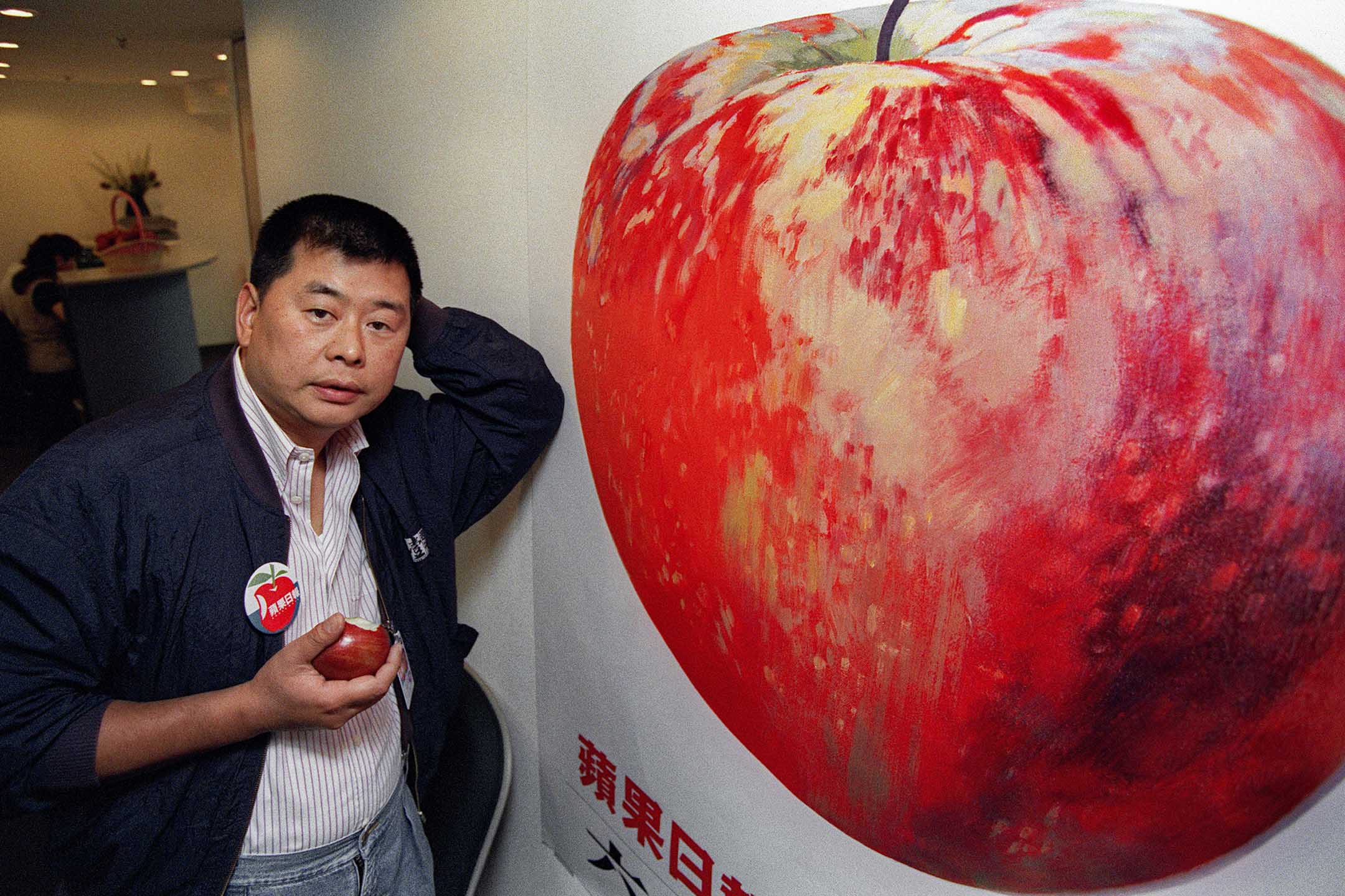 1995年6月14日香港,壹傳媒老闆黎智英在一張海報前。