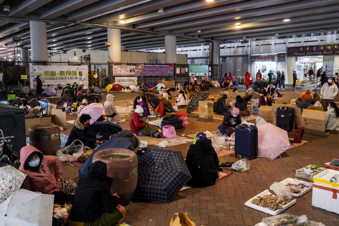 2022年2月20日,美孚地铁站附近一个天桥下,移工在限聚令下二人一组休息。