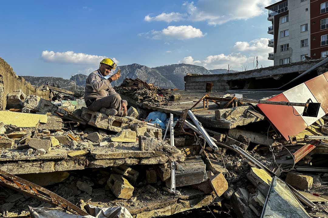 土耳其地震重災區哈泰,一名搜救人員昨在瓦礫上休息,該區約八、九成房屋倒塌或嚴重損毀。