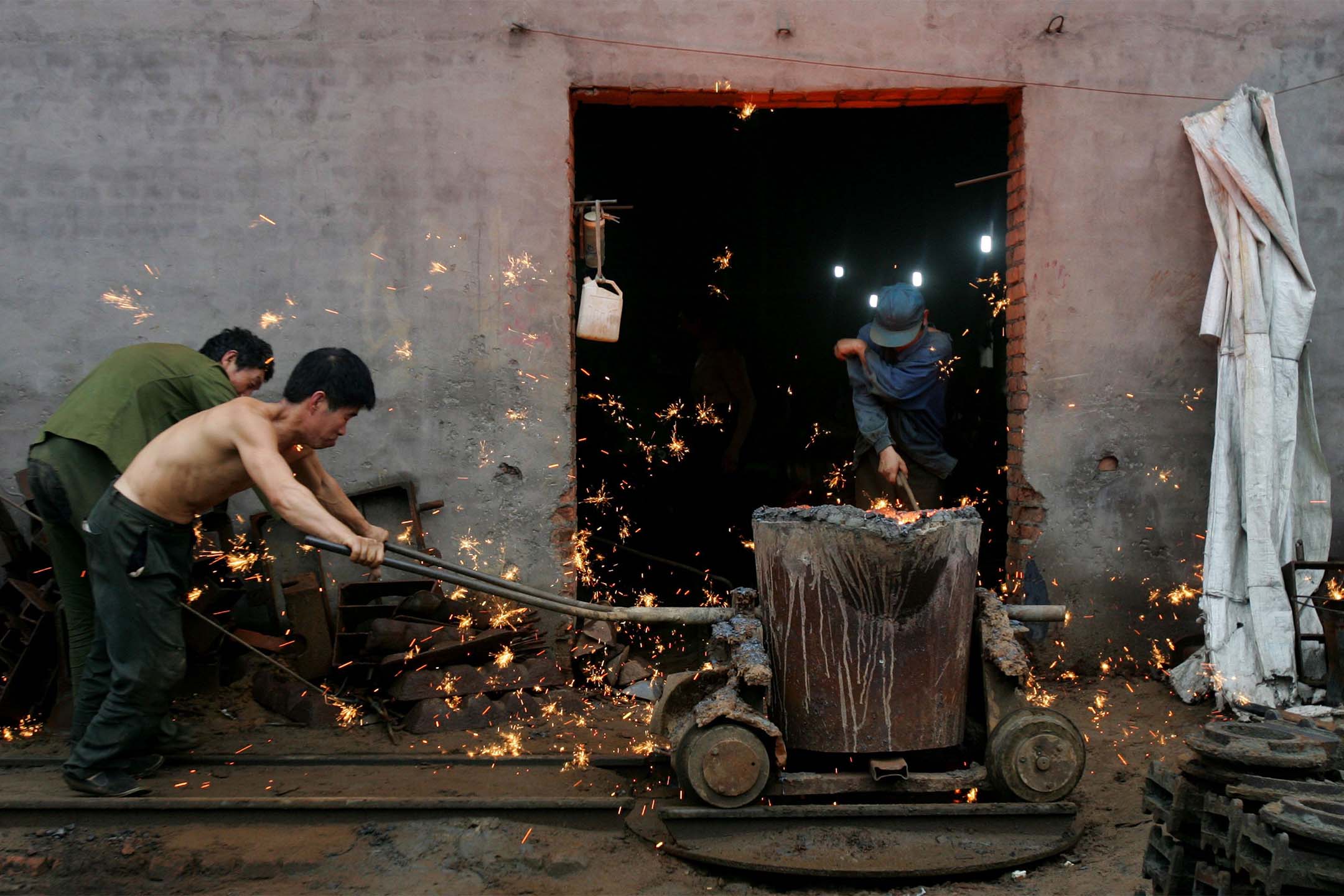 2006年8月30日，中國金州市，工人在鐵器廠工作。攝：China Photos/Getty Images