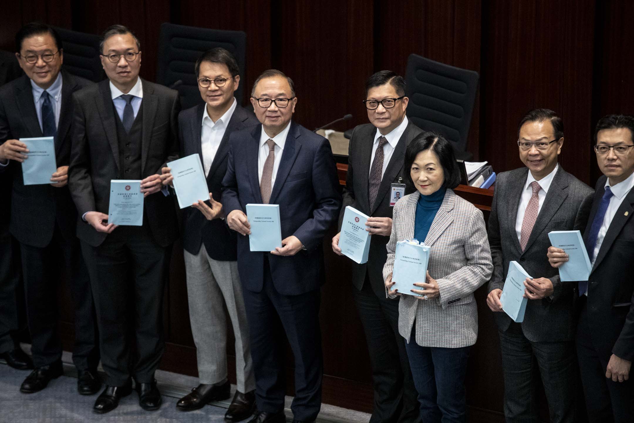 2024年3月14日,立法會法案委員會經過約一週會議後,完成逐條審議《維護國家安全條例草案》,會後律政司司長林定國與保安局局長鄧炳強跟議員合照。攝:林振東/端傳媒