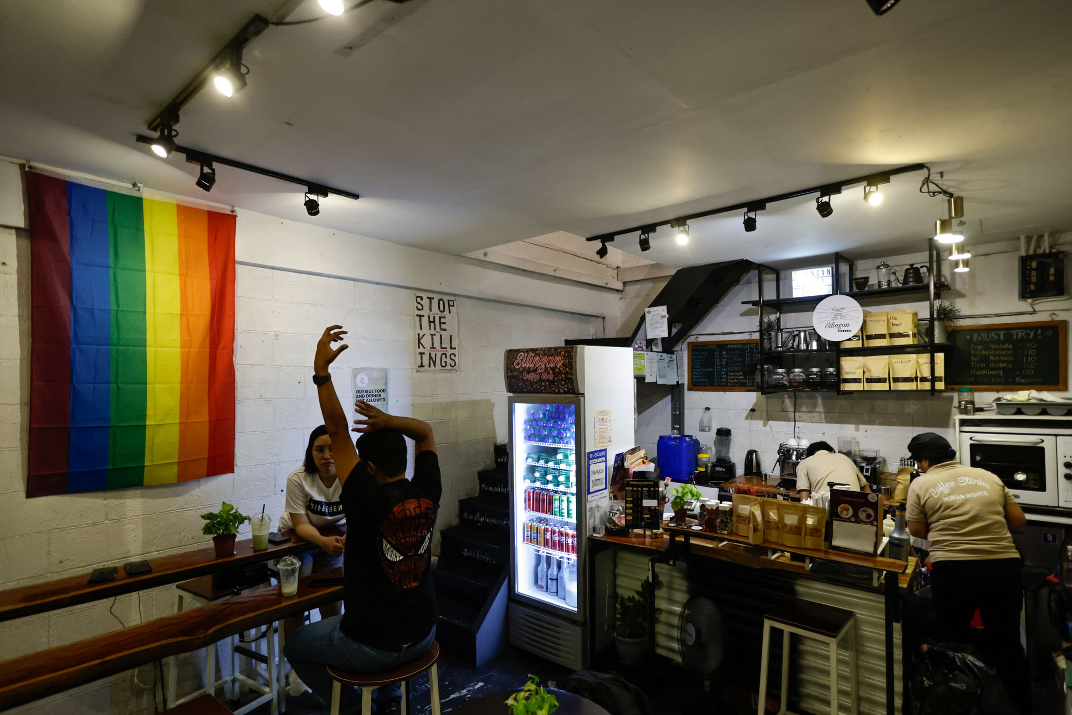 Silingan Coffee格局方正,面积不大,与隔壁一家文青咖啡店风格回异,装潢更平实简单,只有一个开放式厨房、一张吧枱和数张木椅桌。摄:Daniel Ceng/端传媒