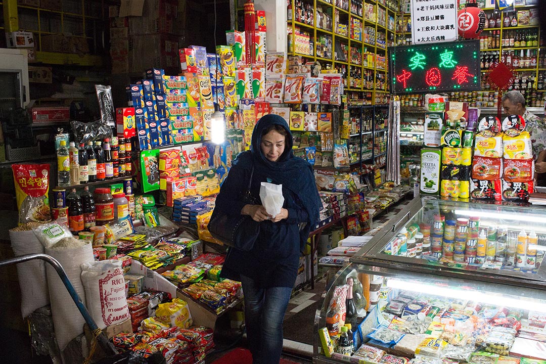 伊朗婦女從一間售賣外國糧油雜貨的店鋪離開。攝: Arash khamooshi /端傳媒