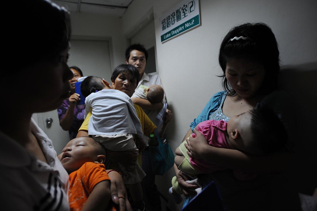 2008年9月17日,中國奶粉被揭發添加了三聚氰胺,中國湖北省武漢一間醫院,家長帶同小孩檢查身體。攝:China Photos/Getty