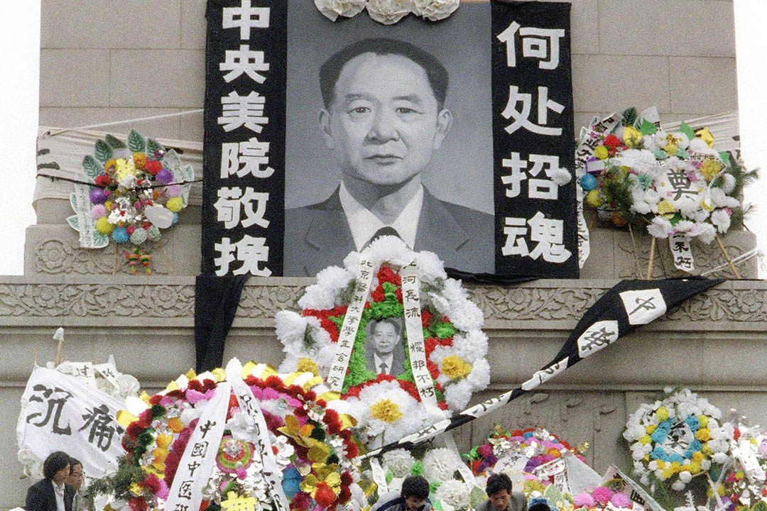 1989年4月19日,北京,学生在天安门广场人民英雄纪念碑向已故中共总书记胡耀邦献花。