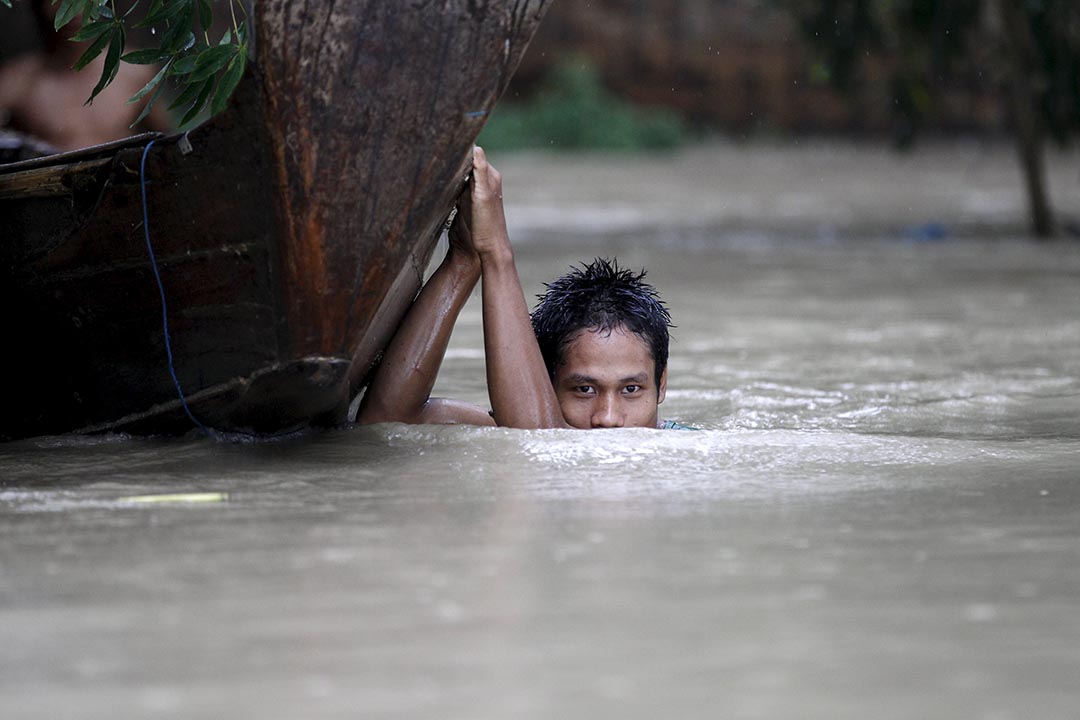男子在緬甸水浸災區拉動他的小艇。攝: Soe Zeya Tun /REUTERS